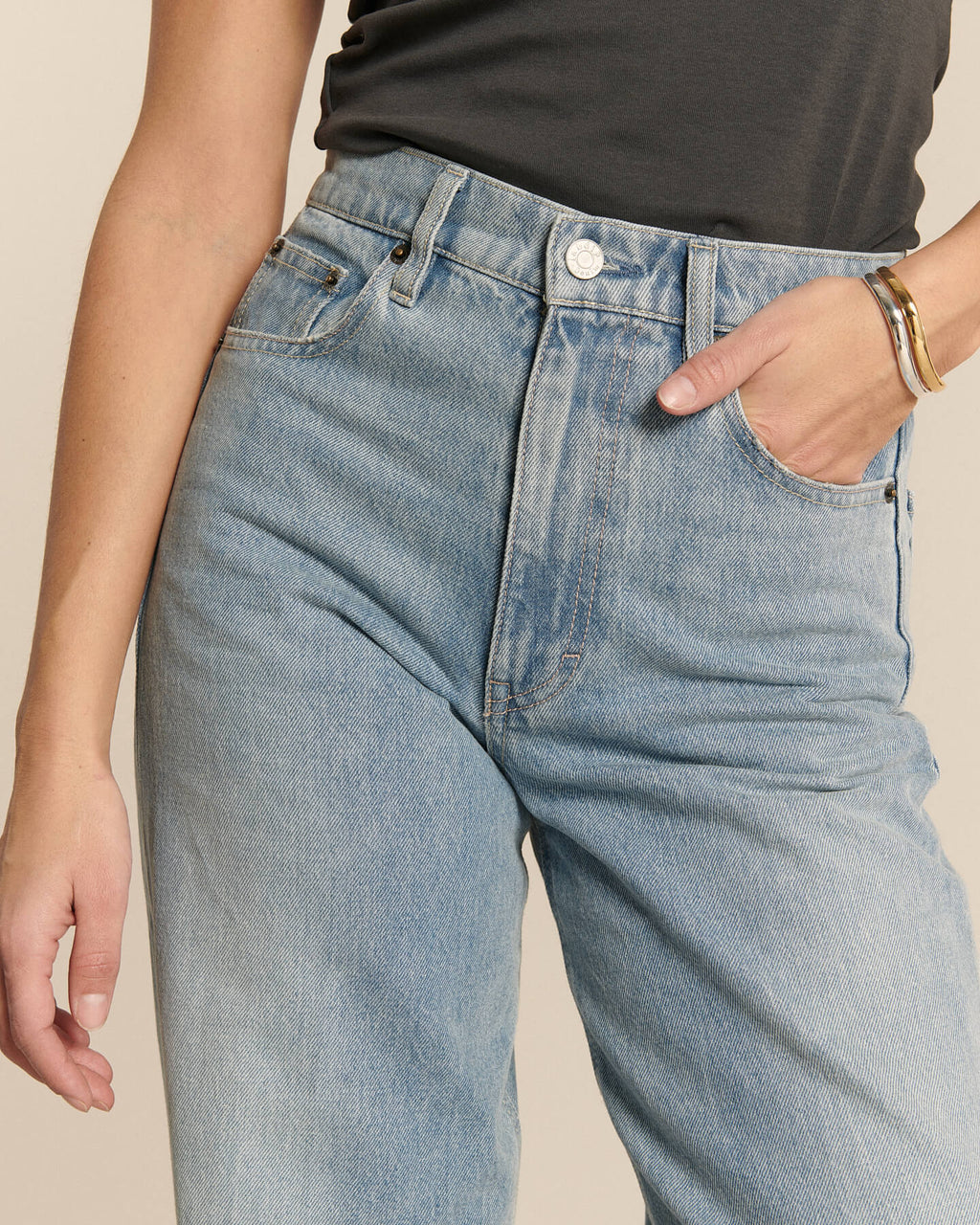 Jean en denim clair stone bleach avec coupe droite et taille haute, matière en coton douce adaptée pour femme, offrant un style estival et décontracté.