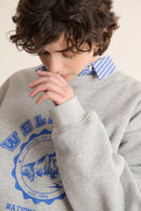 Imprimé visuel centré sur le devant, finition mate avec contours nets intégrés directement dans la matière du sweat.