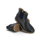 Pom d'Api – Pom D'Api - Trip Jodzip - Marine, deux bottines en cuir bleu marine avec semelles marron clair, posées