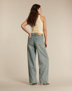 Jean en denim bleu clair avec une coupe droite et large, matière en coton souple, idéal pour une silhouette féminine adaptable à toutes les morphologies.