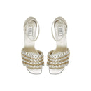 Elegant silver high-heeled sandals with unique braided design and ankle strap, perfect for formal occasions.