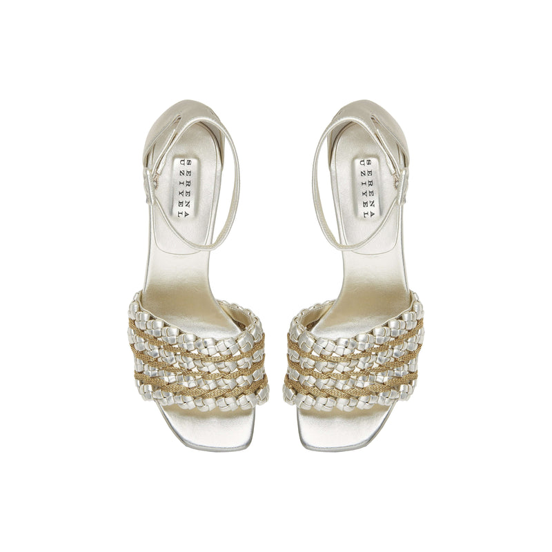 Elegant silver high-heeled sandals with unique braided design and ankle strap, perfect for formal occasions.