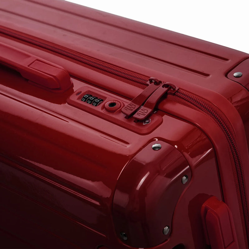 Cierre combinado TSA y cremallera de doble cursor GYL en la maleta rígida Intemporelle de color rojo oscuro. #color_rojo_oscuro