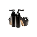 Elegant Catena Black Platform Ankle Sandals featuring chunky block heels and wrapped chain embellishments.