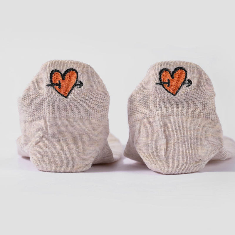 zoom sur les languettes de chaussettes beige avec coeurs fleches