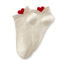 Chaussette unie avec petit cœur rouge brodé.
