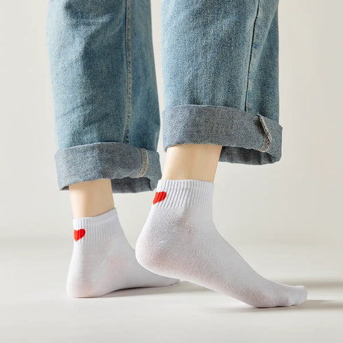 Mid-height sock with red heart on the heel