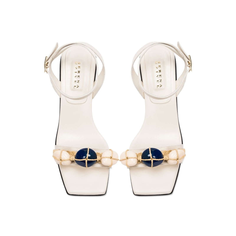 Delphine 50MM Ankle Cross Sandal in ivory with aqua beads and wide straps, blending nature-inspired colors.