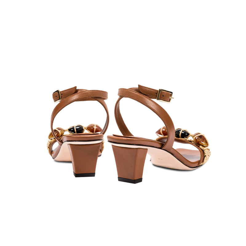 Delphine Camello mid-heel ankle cross sandals featuring a chic brown design with decorative details and secure buckle.