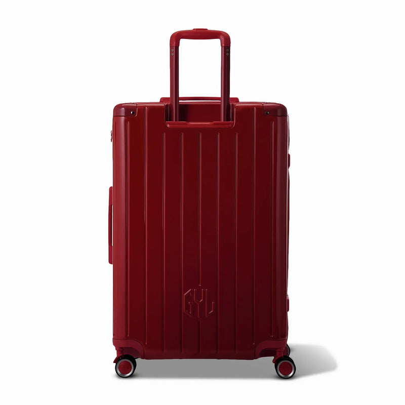Vue arrière de la valise rigide GYL Intemporelle rouge foncé avec poignées intégrées et roulettes pivotantes. #couleur_rouge foncé