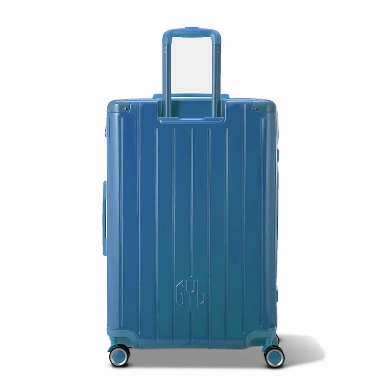 Vista trasera de la maleta rígida GYL Intemporelle negra con asas integradas y ruedas giratorias. #color_gris_azul