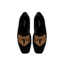 Fiocco black velvet flat moccasin with antique gold embroidered bow, highlighting comfort and chic autumn style.