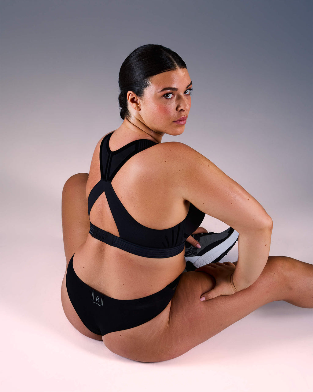woman wearing a hastko BRA N°38 sports bra #color_true-black
