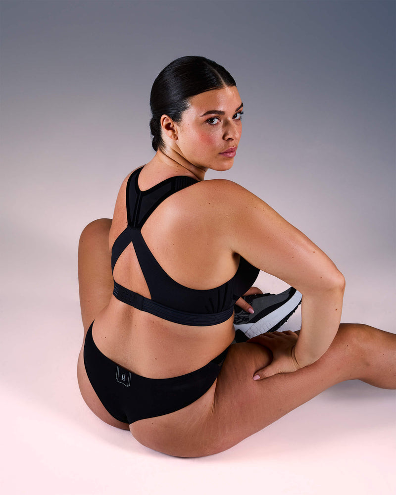 woman wearing a hastko BRA N°38 sports bra #color_true-black