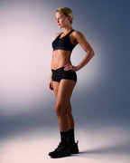 woman wearing a hastko BRA N°38 sports bra #color_true-black