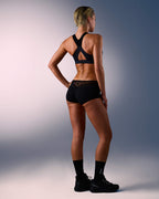 woman wearing a hastko BRA N°38 sports bra #color_true-black