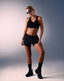 woman wearing a hastko BRA N°38 sports bra #color_true-black