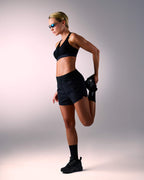 woman wearing a hastko BRA N°38 sports bra #color_true-black