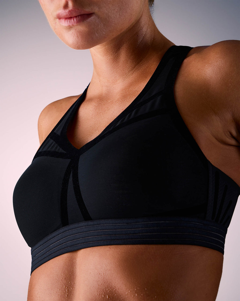 woman wearing a hastko BRA N°38 sports bra #color_true-black