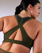 woman wearing a hastko BRA N°38 sports bra #color_kaki