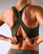 woman wearing a hastko BRA N°38 sports bra #color_kaki