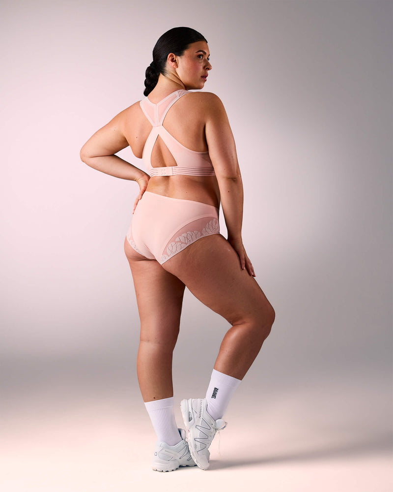 woman wearing a hastko BRA N°38 sports bra #color_nude