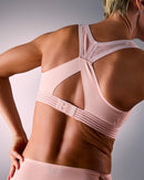 woman wearing a hastko BRA N°38 sports bra #color_nude