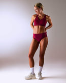 woman wearing a hastko BRA N°38 sports bra #color_tuscany-bordeaux