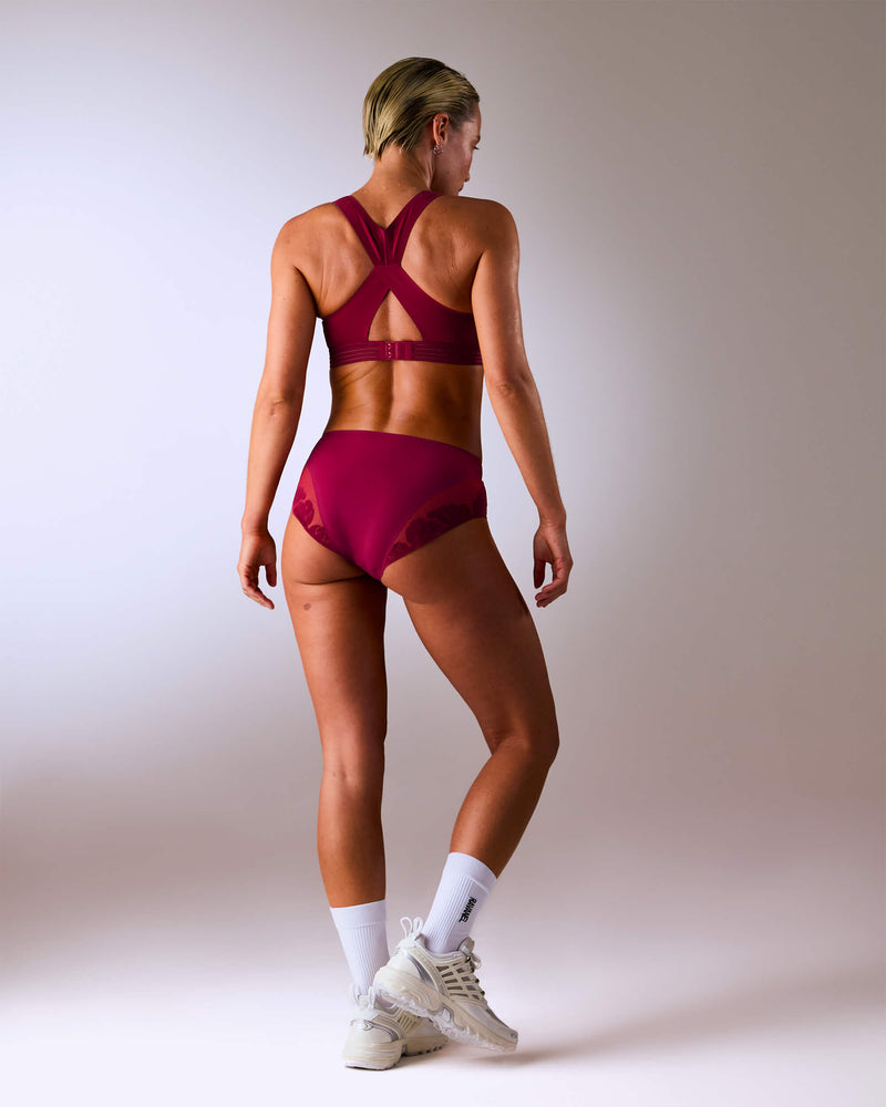 woman wearing a hastko BRA N°38 sports bra #color_tuscany-bordeaux
