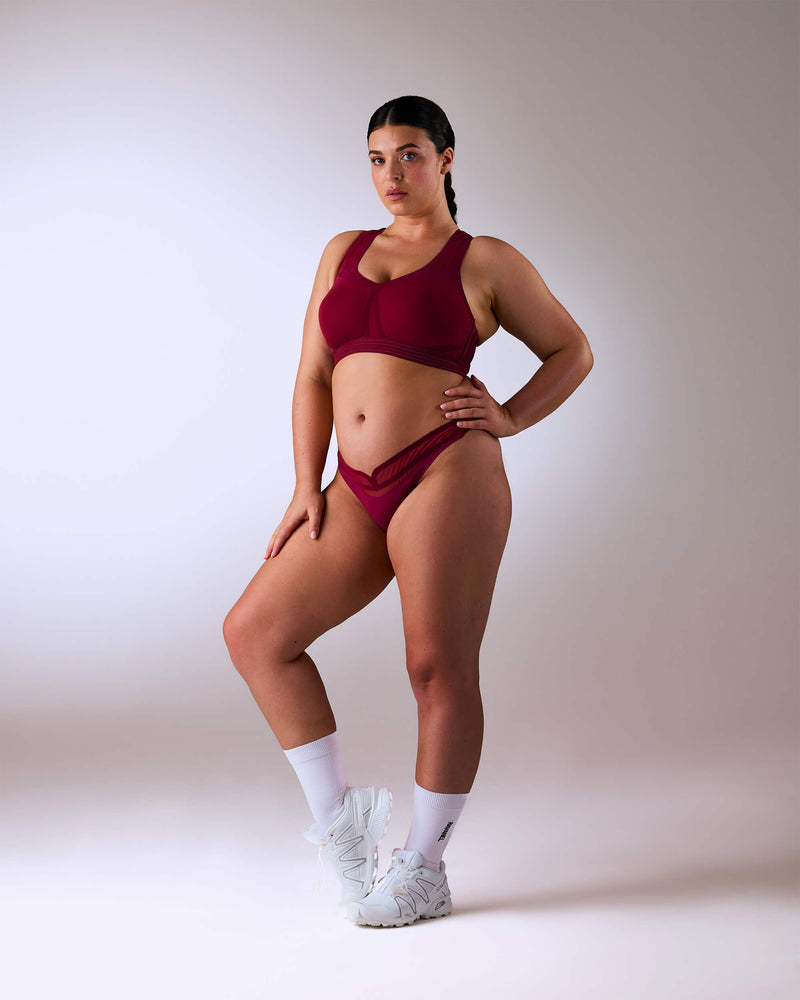 woman wearing a hastko BRA N°38 sports bra #color_tuscany-bordeaux