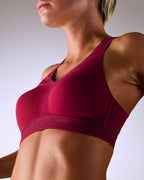 woman wearing a hastko BRA N°38 sports bra #color_tuscany-bordeaux