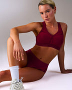 woman wearing a hastko BRA N°38 sports bra #color_tuscany-bordeaux