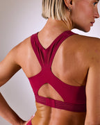 woman wearing a hastko BRA N°39 sports bra #color_tuscany-bordeaux