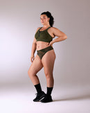 woman wearing a hastko BRA N°42 sports bra #color_kaki