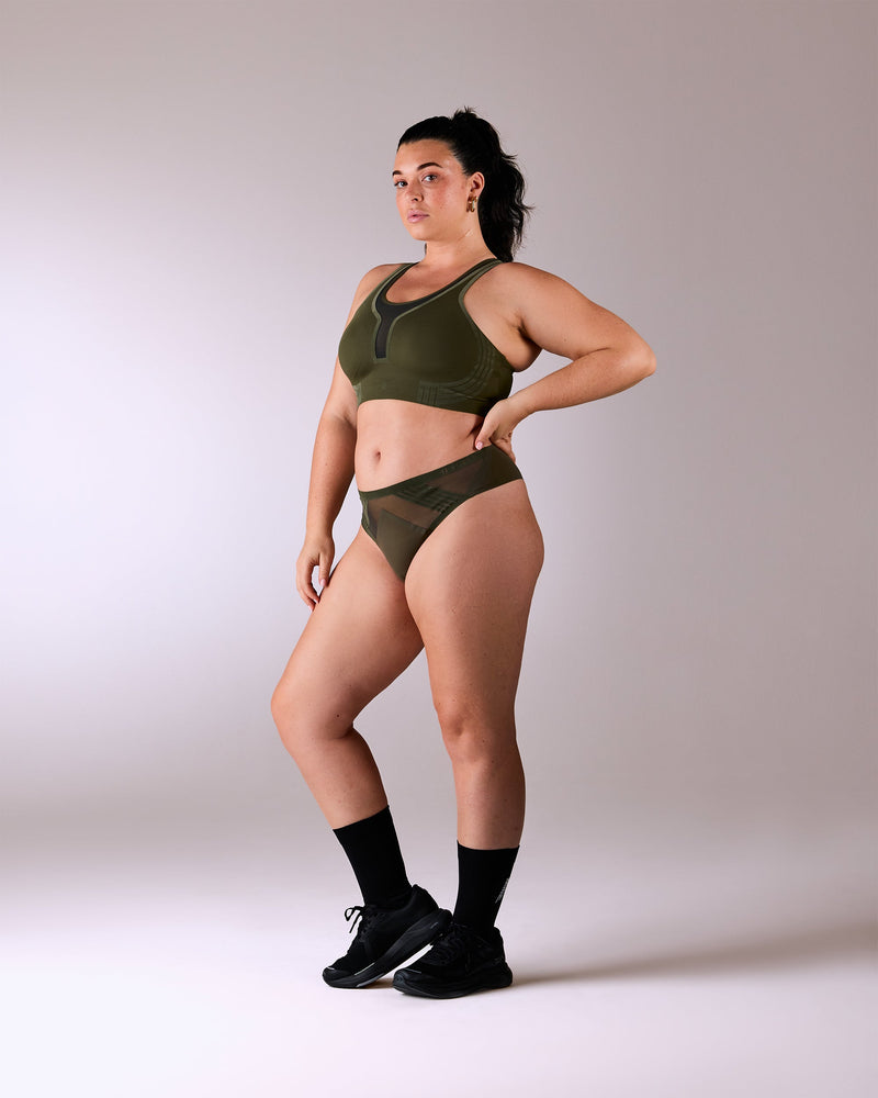 woman wearing a hastko BRA N°42 sports bra #color_kaki