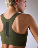 woman wearing a hastko BRA N°42 sports bra #color_kaki