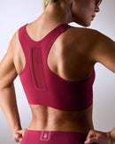 woman wearing a hastko BRA N°42 sports bra #color_tuscany-bordeaux