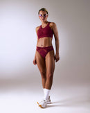 woman wearing a hastko BRA N°42 sports bra #color_tuscany-bordeaux