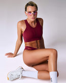 woman wearing a hastko BRA N°42 sports bra #color_tuscany-bordeaux