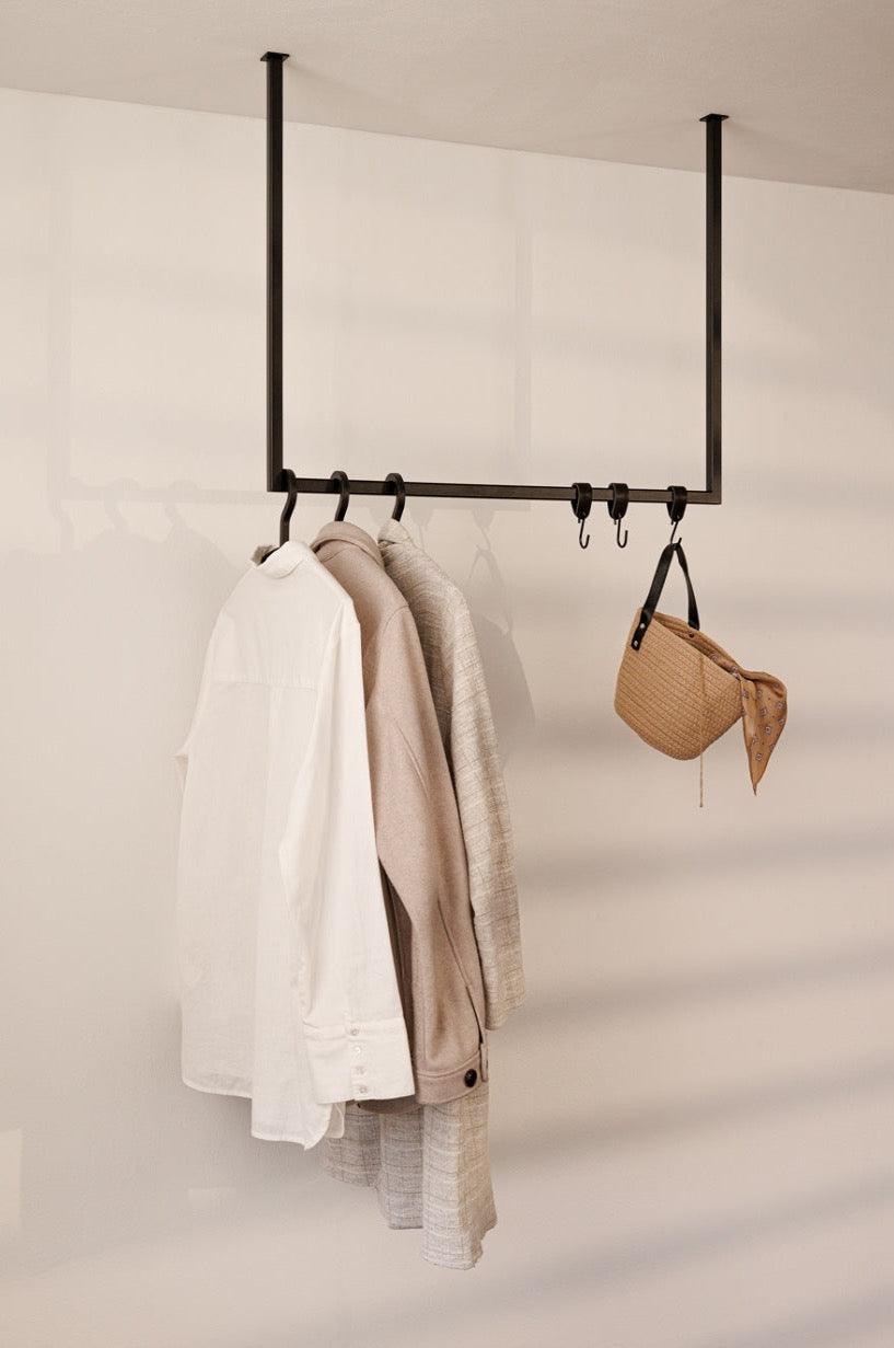 RUBI clothes with white hemden and one bag on the wall, elegant minimalist design for your ankle strap.