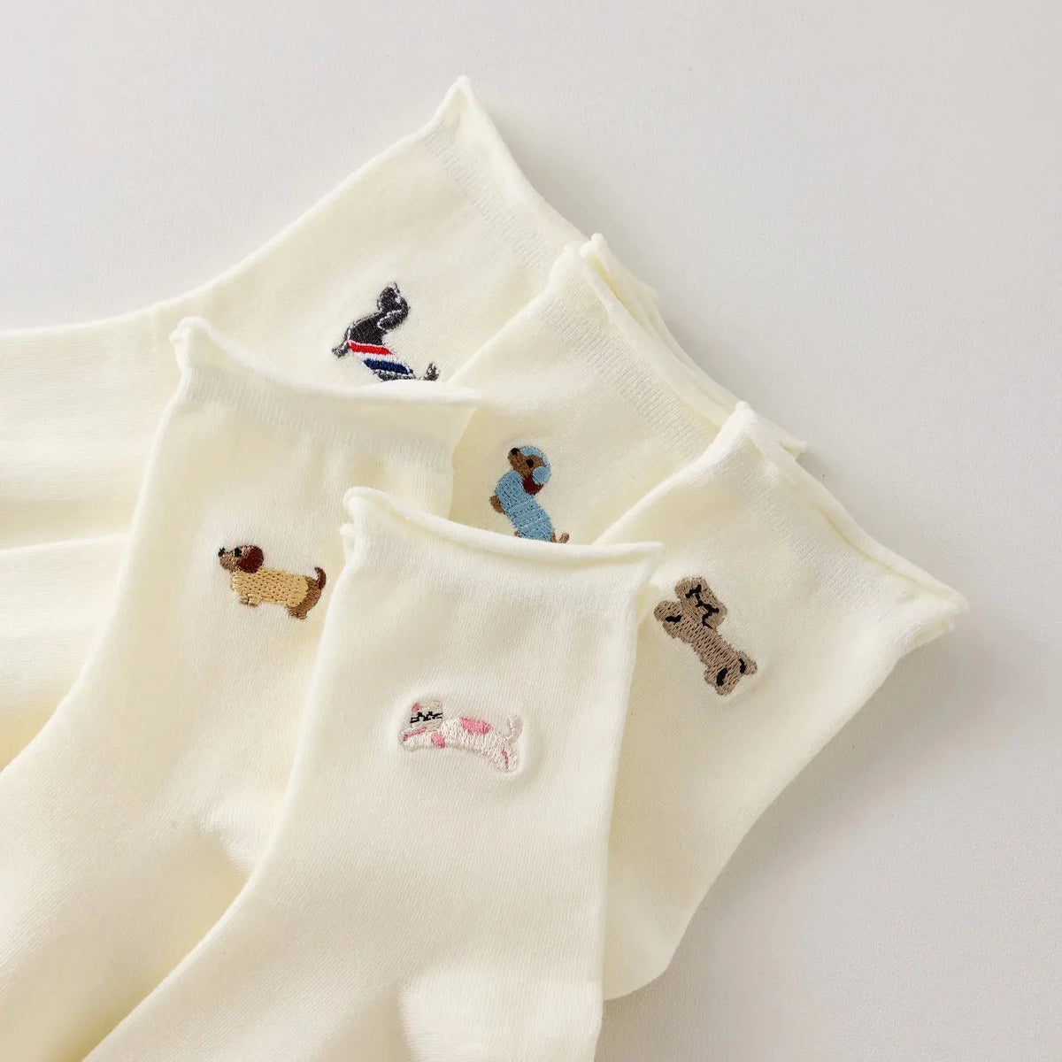 Lot de 5 chaussettes hautes femme crème, brodées de chiens ou chats. Motifs différents, maille douce et bord roulotté. Taille 35-41. Originales et confortables.