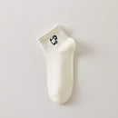 Lot de 3 chaussettes femme noir et blanc avec broderies chien. Motifs graphiques, maille douce et taille 35-41. Style original et confort assuré.