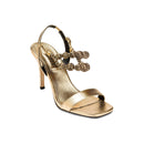 Lyra Gold High-Heel Sandal featuring lustrous leather, slingback straps, and handwoven embellishments.