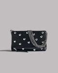 Black studded bag with chain detail on a gray background