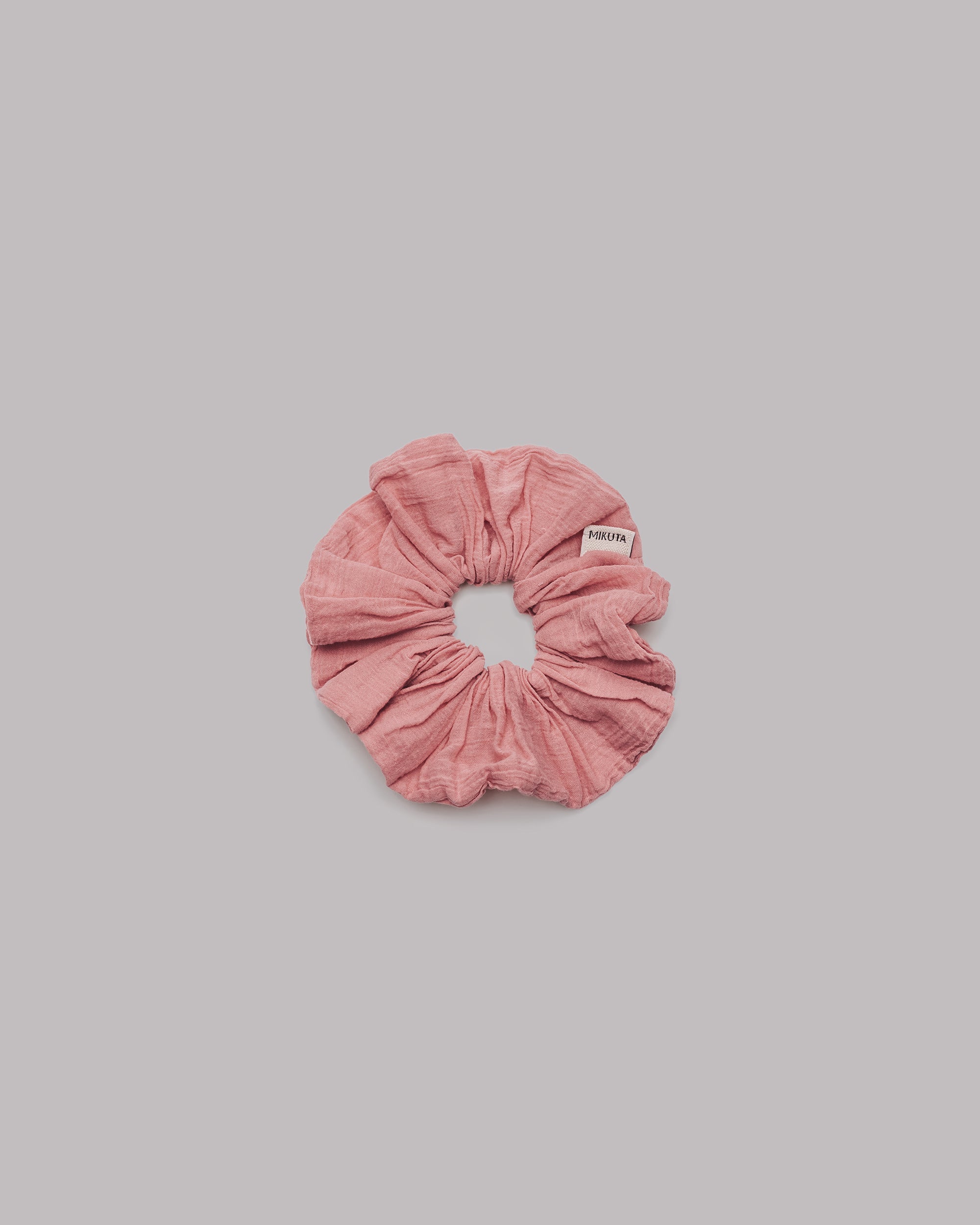 Pink scrunchie on a gray background
