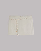 Light mini skirt with decorative shells on a light gray background