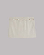 Beige skirt with shell details on a light gray background