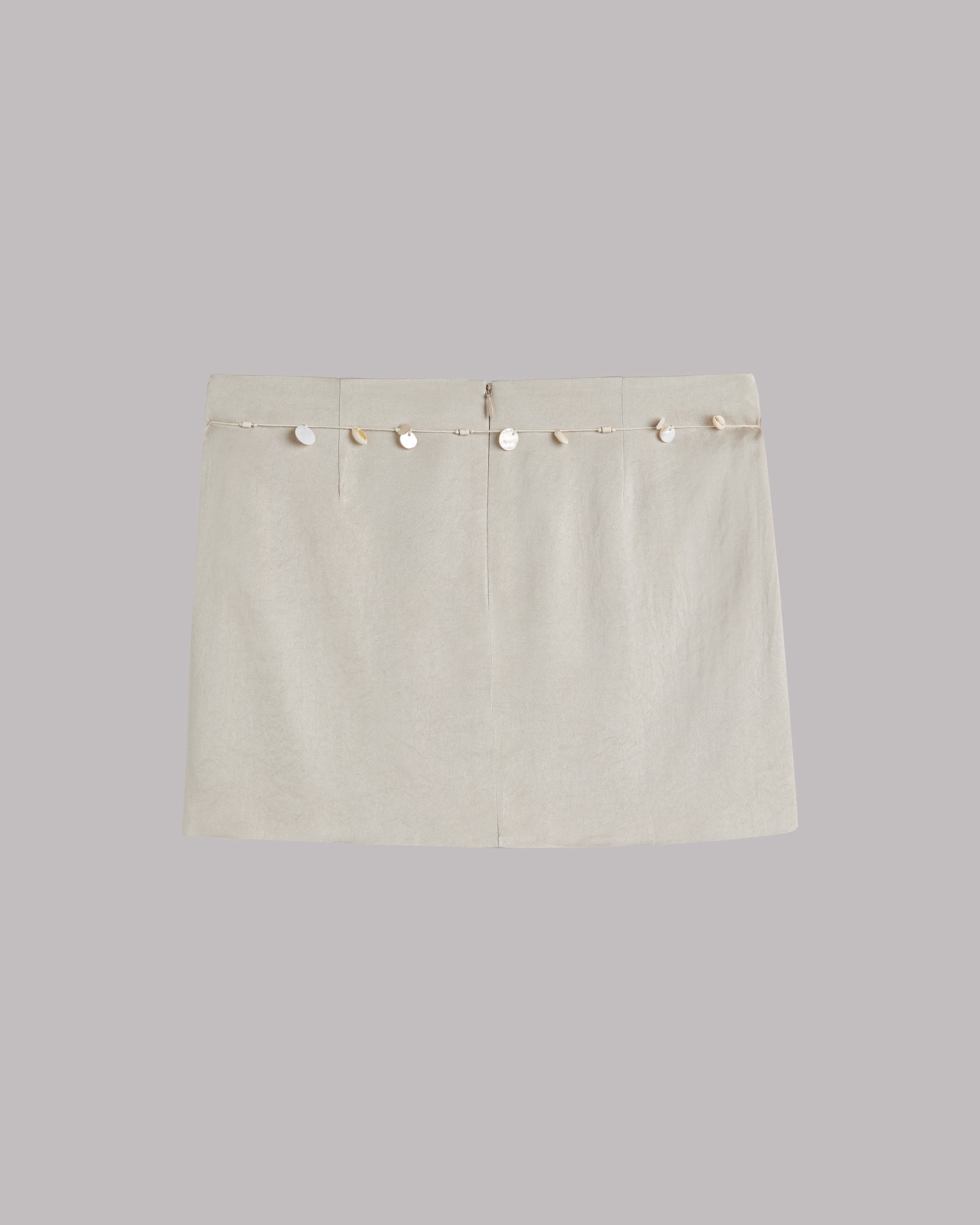 Beige skirt with shell details on a light gray background