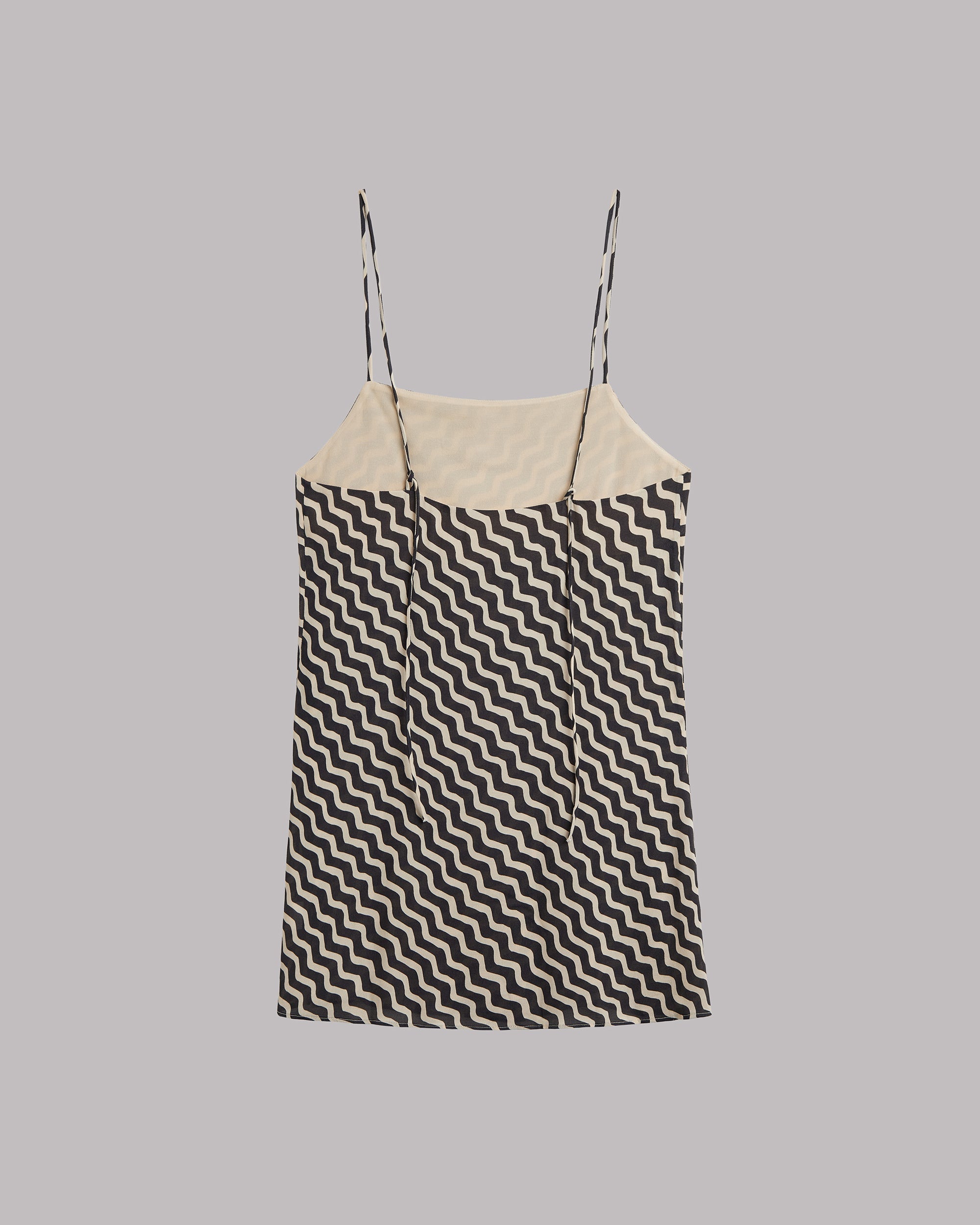 Sleeveless dress with Black and white zigzag pattern on a gray background