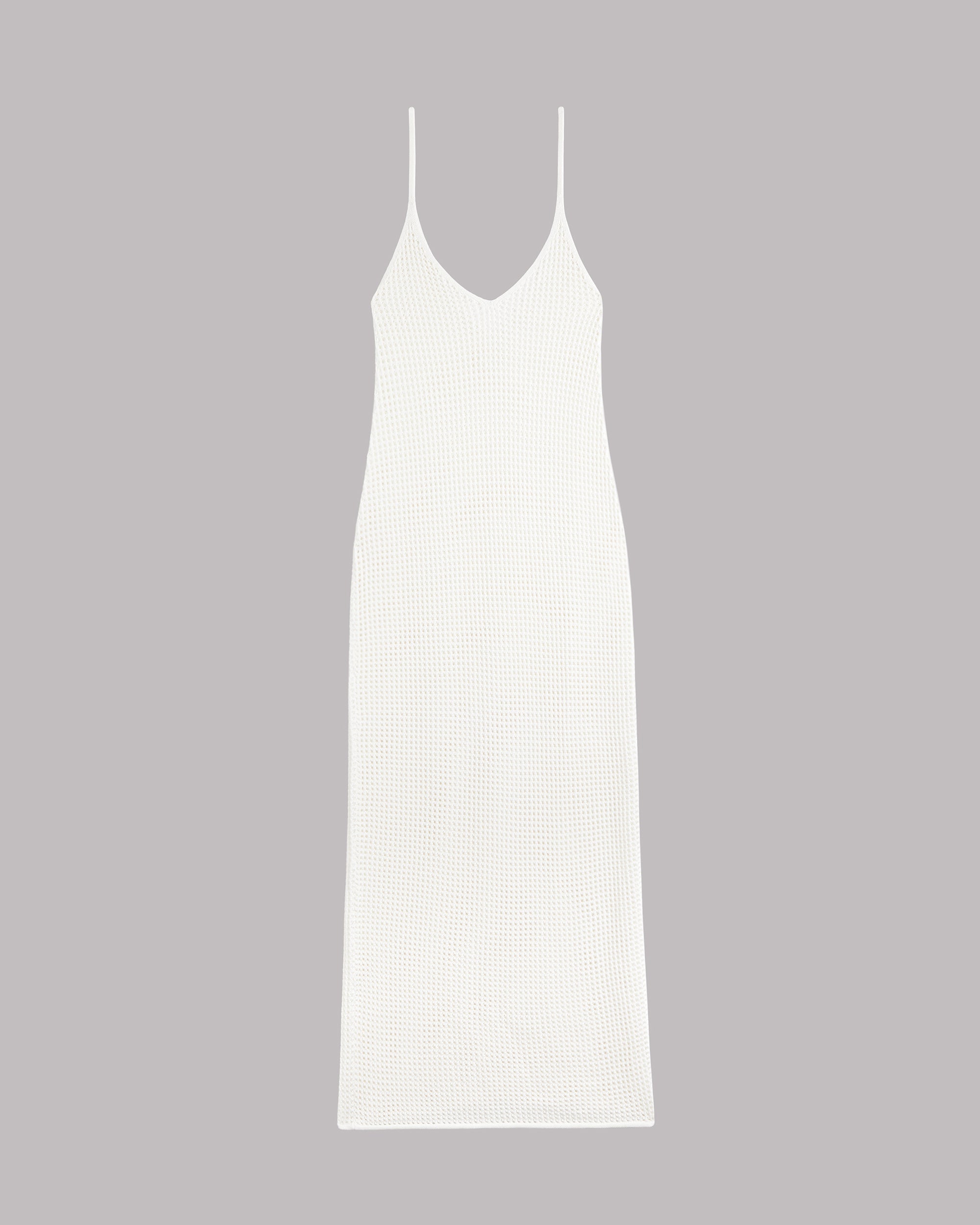 White slip knitted dress on a gray background